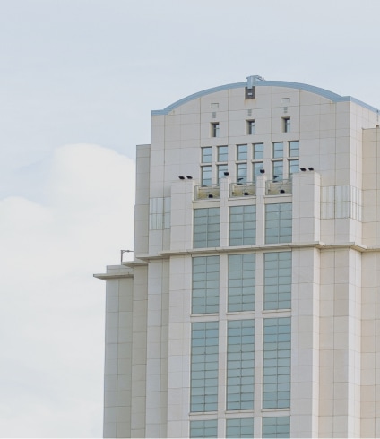 A large building with many windows and some lights on it