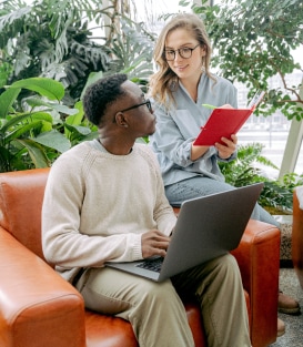 A man sitting on top of a couch next to a woman.