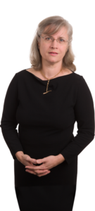 A woman in black shirt and gold necklace.